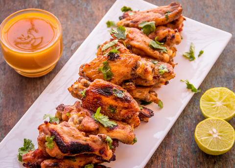 Chicken wings with side sauce and lemon
