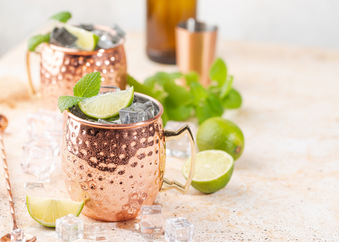 Kentucky mules with mint and lime wedge garnish in copper mugs