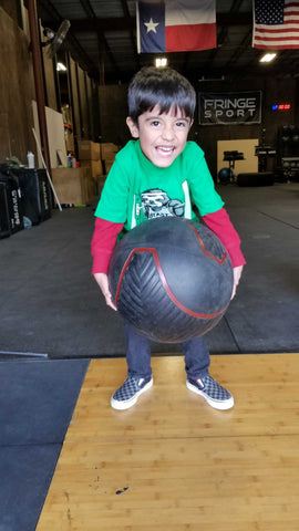 strongman for kids; kid lifting ball
