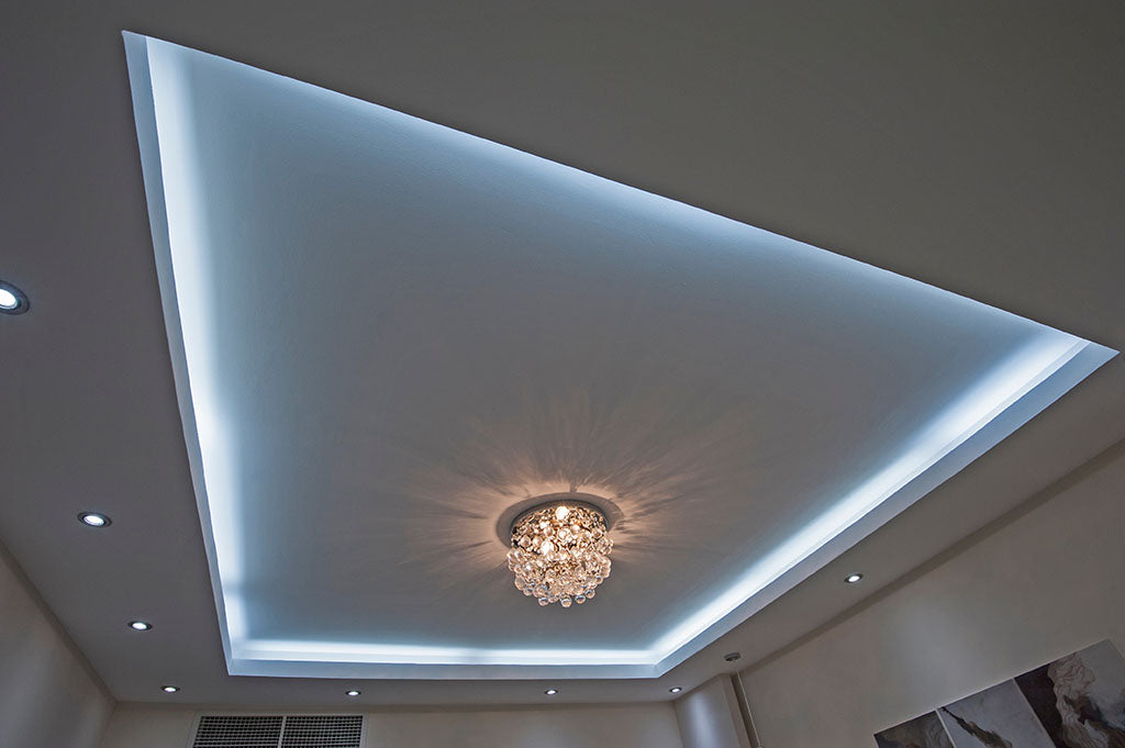 A drop ceiling with LED lighting and a central chandelier