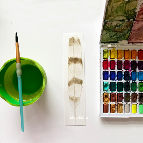 Watercolor feather bookmark with Watercolors in a Pan and a water cup