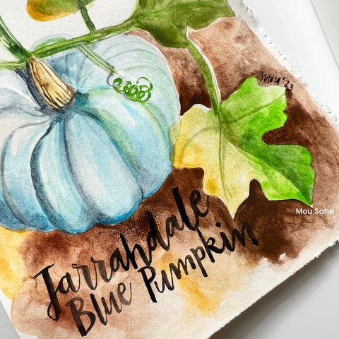 Hand lettering on a watercolor pumpkin painting