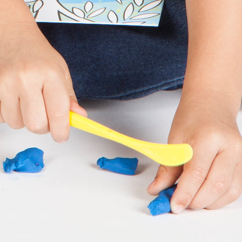 Child cutting clay