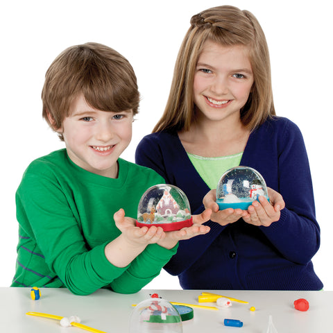 Two kids with holiday snow globes