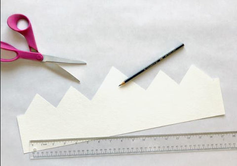 Paper crown with scissors, pencil, and ruler