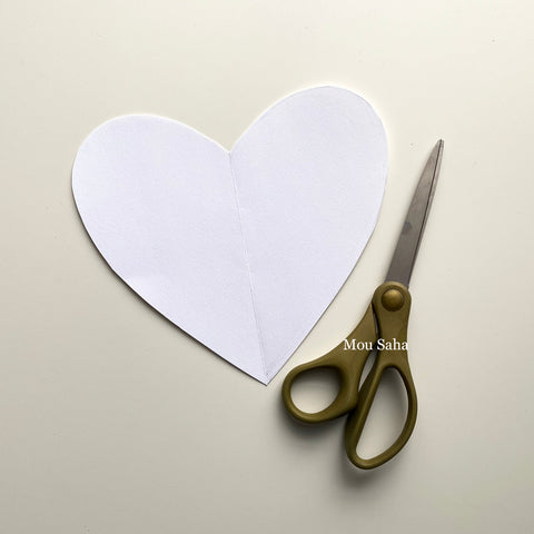 Cut out paper heart with scissors
