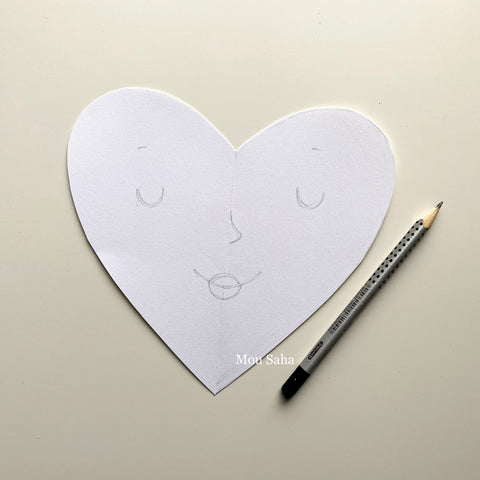paper heart with face and graphite pencil