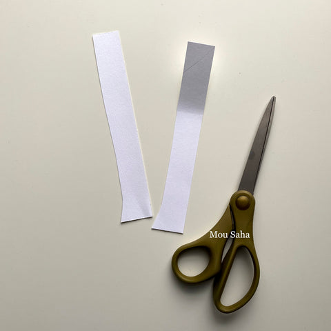 Two paper strips and scissors
