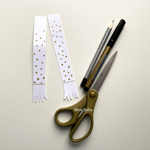 Two paper strips with a pencil, Pitt Artist Pen, and scissors