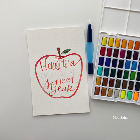 Watercolor pan with hand lettering in apple