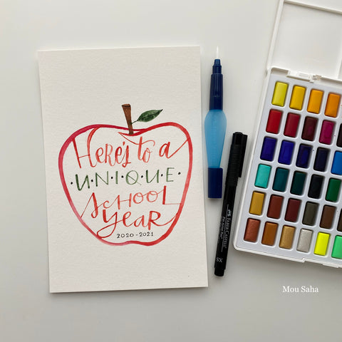 Watercolor pan with hand lettering in an apple