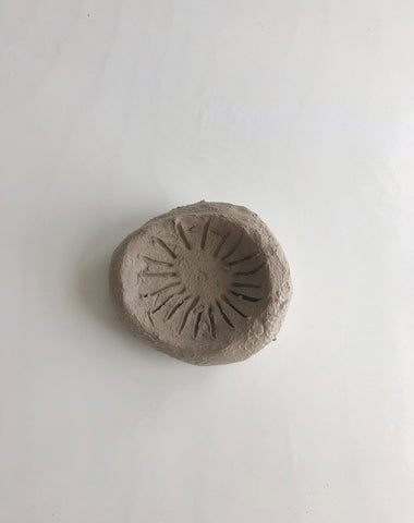 Clay pushed into mushroom cap shape