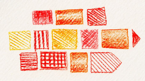 Yellow, red, and orange shapes sketched on hot press paper