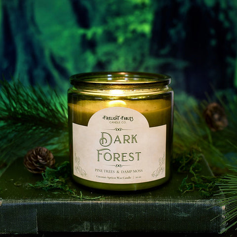 A close up of Firelight Fables' Dark Forest scented candle