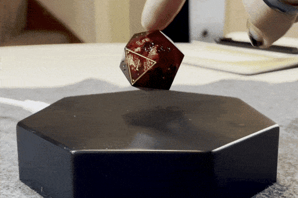 GIF of the dice being pushed and still floating stably