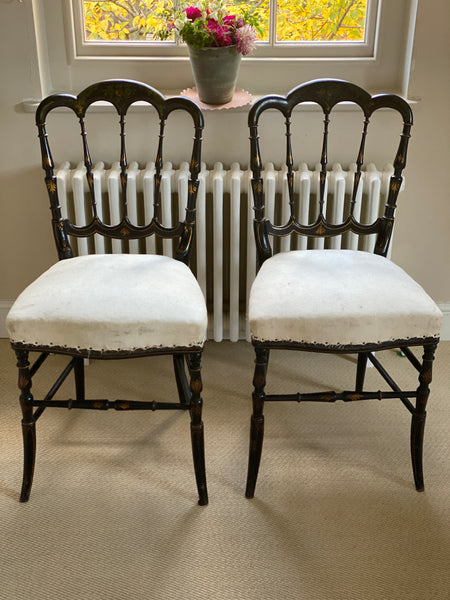 A Pretty Pair of Black Painted Chairs with covered seats