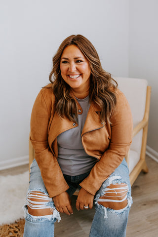 Misty wears a tan suede jacket paired with ripped skinny jeans