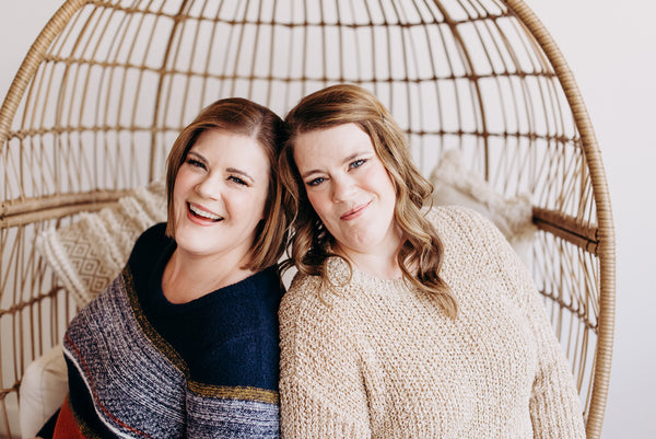 Leslie and Stacey Malmgren, owners of Love Marlow Boutique in Sioux Falls SD, smile for a photo wearing sweaters from their new fall line of Plus Size Clothes. 