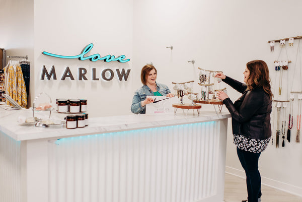 Stacey and Leslie Malmgren, owners of Love Marlow Boutique in Sioux Falls SD, stand by the register surveying their new inventory of jewerly. 