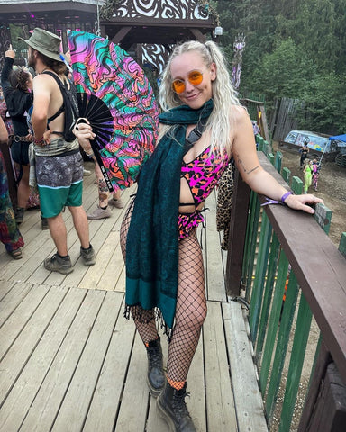 A One Stop Rave customer wearing a One Stop Rave rave scarf or rave pashmina and holding a One Stop Rave hand fan