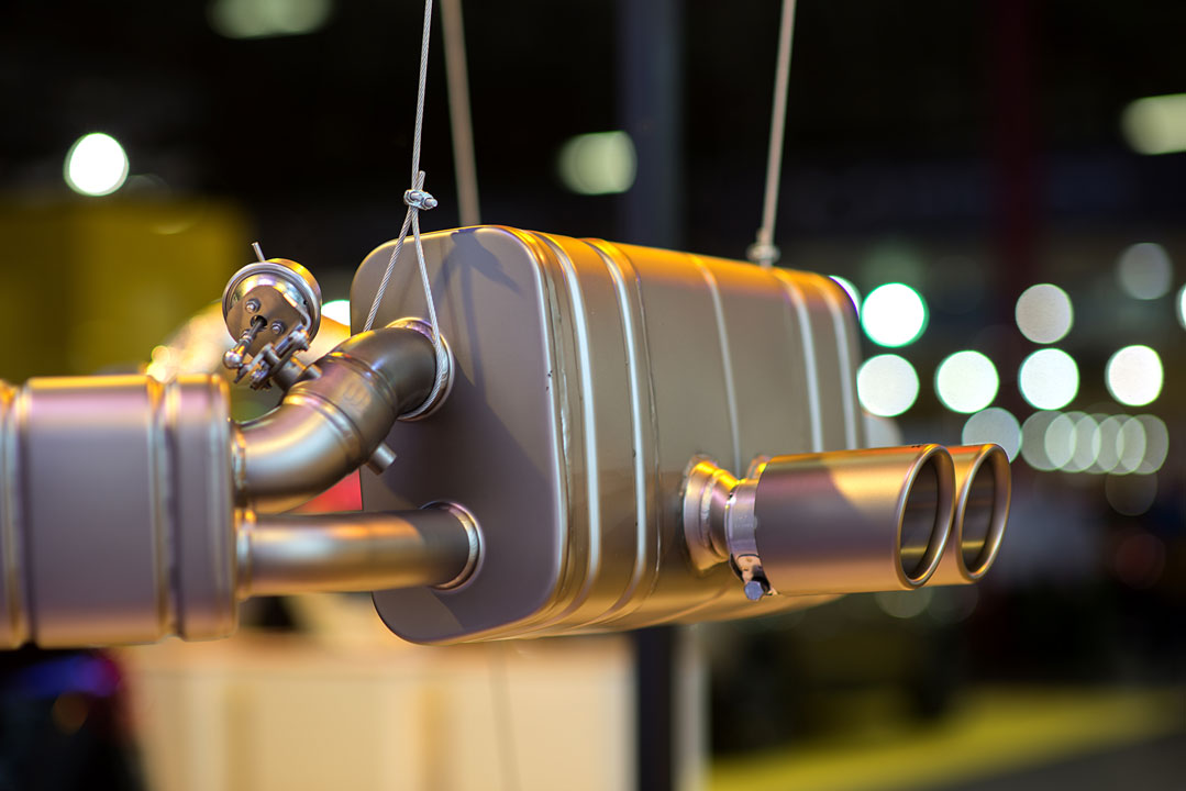 An image of a exhaust muffler and the exhaust tip suspended with a rope attached