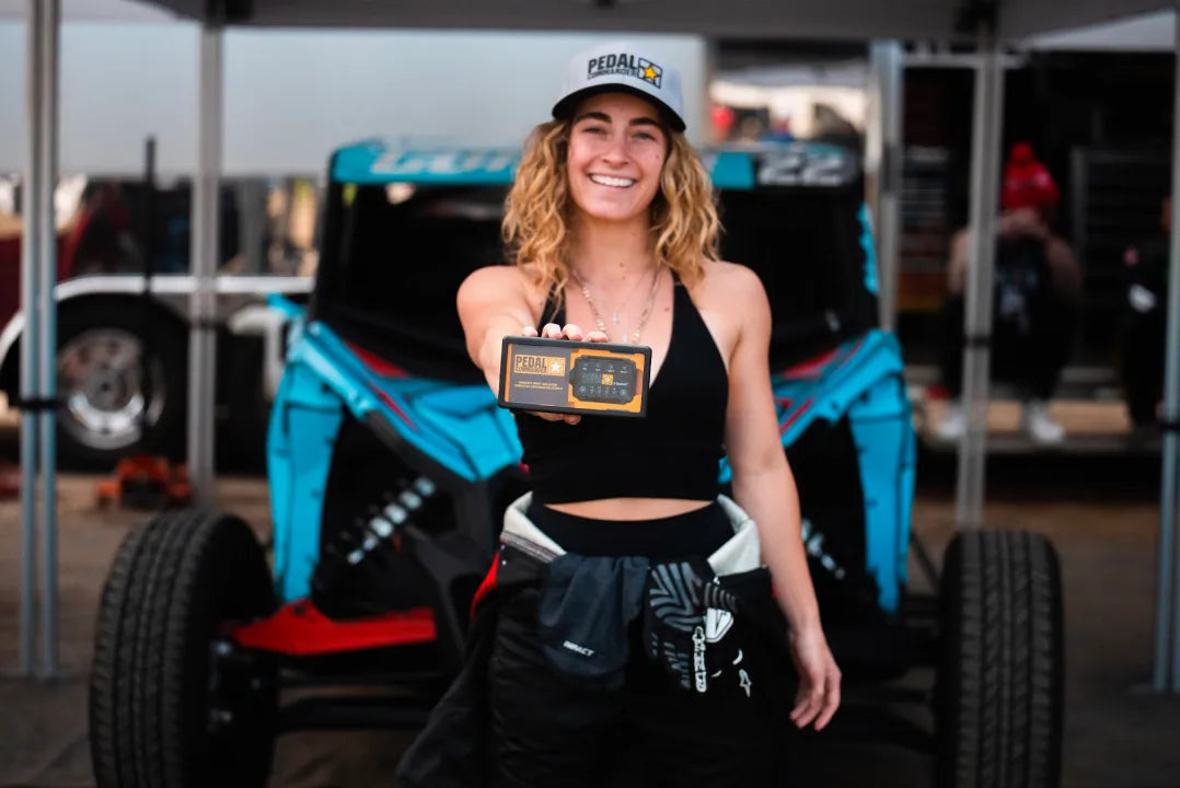 Fitness Influencer and Racer Dami Bagby holding a Pedal Commander