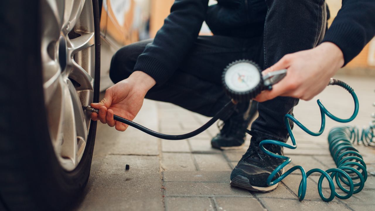 man-checking-tire-pressure