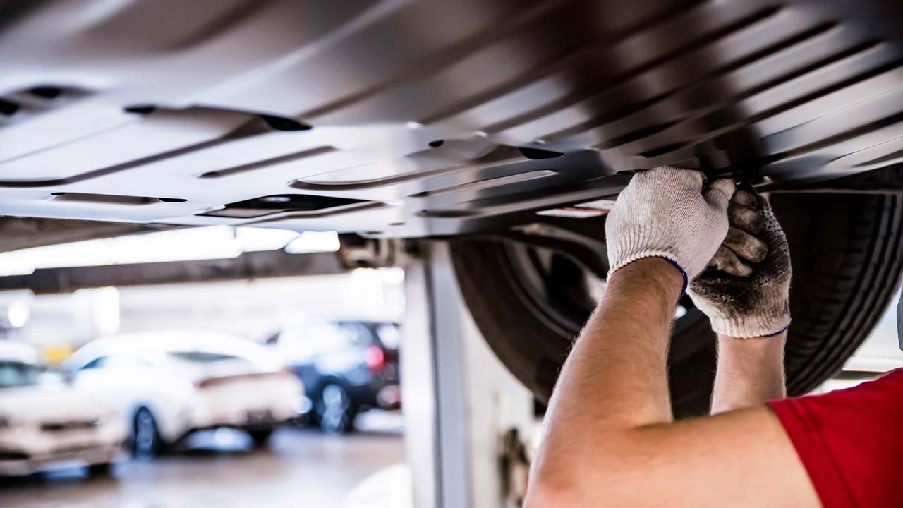 man-doing-maintenance-under-car