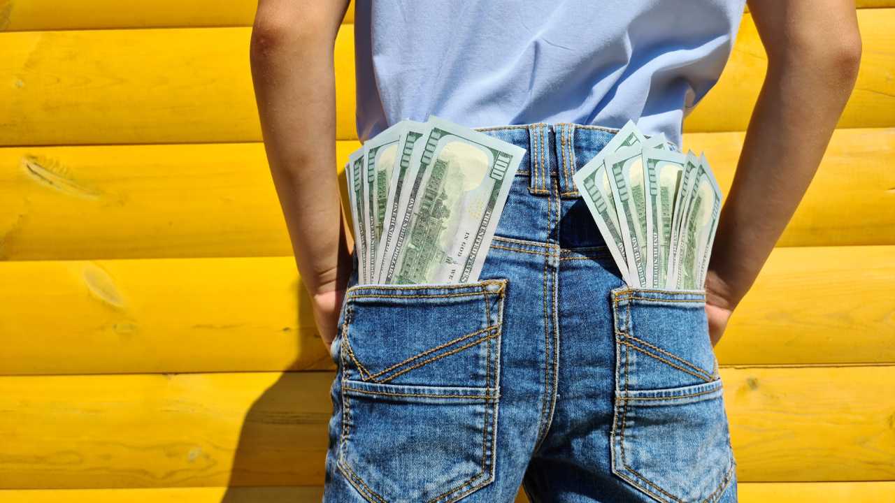 man with cash filled pockets