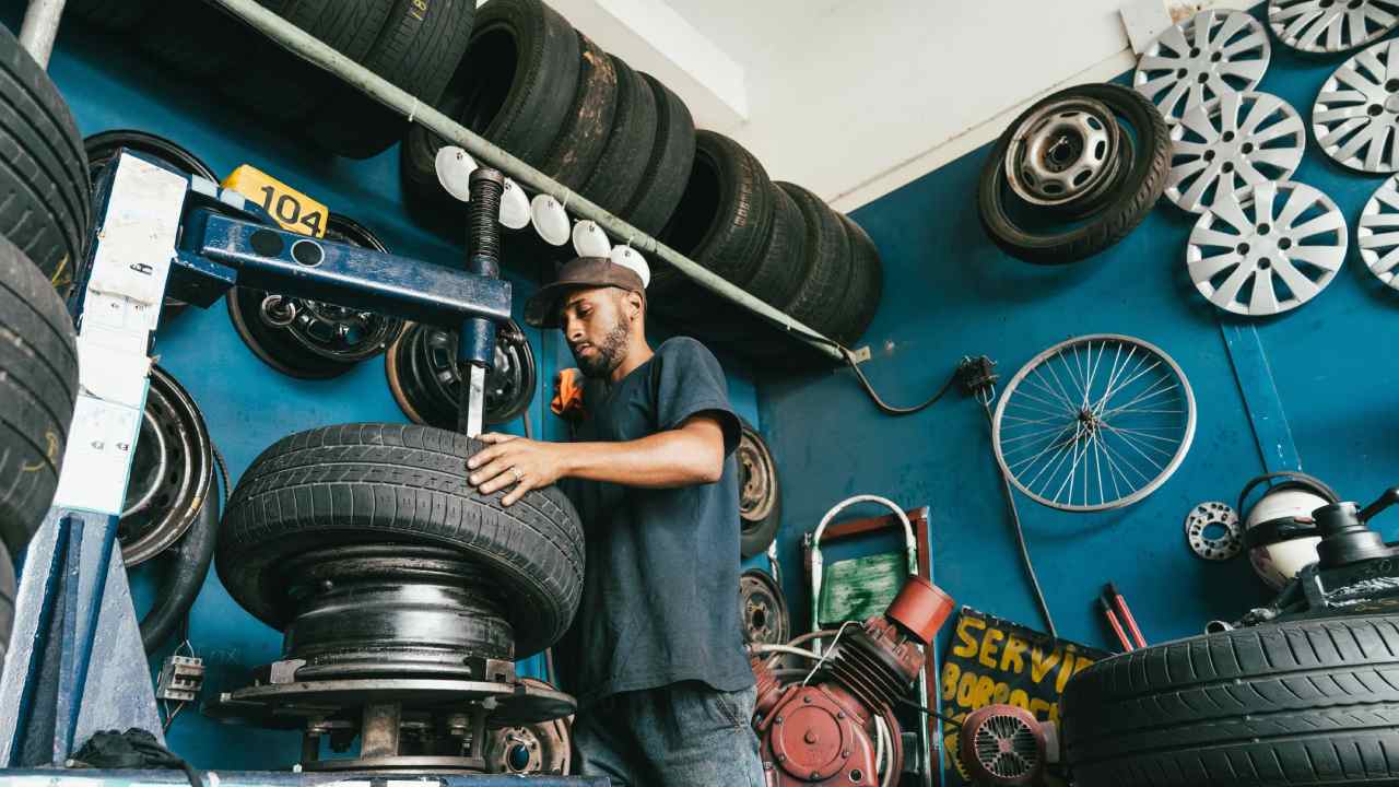 man fixing car tire