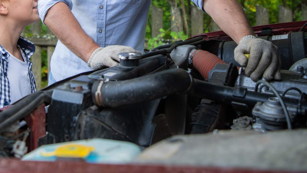 Father and son doing their own oil change