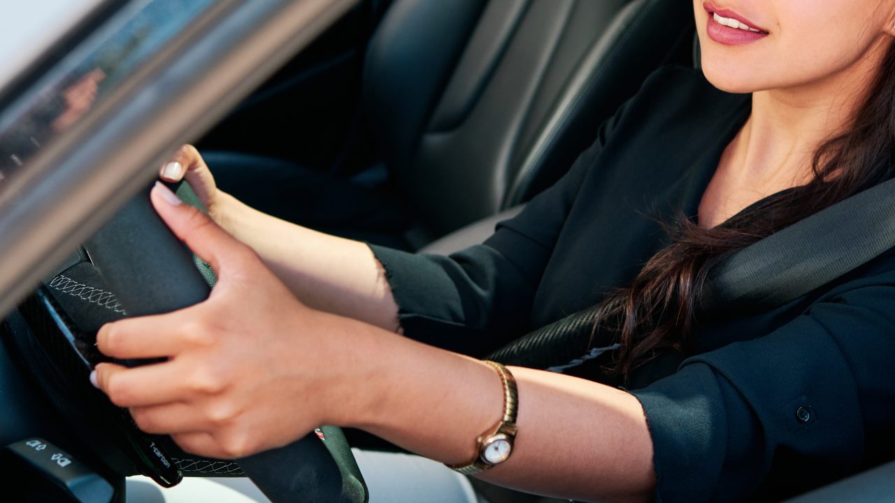 latino woman driving a car