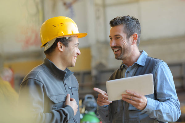 Visual representation of a construction worker consulting a financial advisor