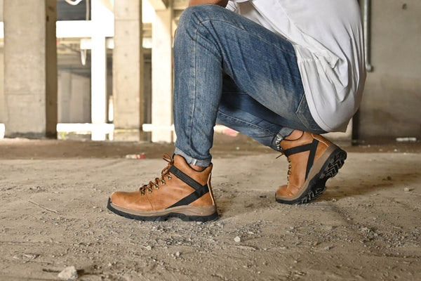 A man wearing Indestructible Shoes on a worksite.