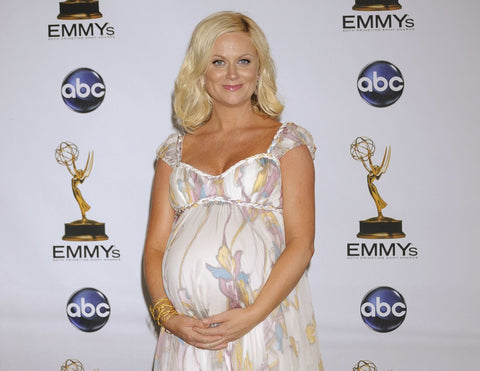 Amy Poehler, pregnant in a white floral dress at the Emmys.