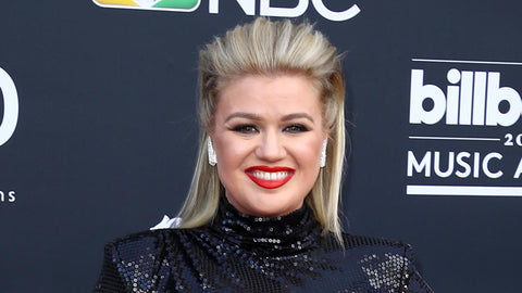 Kelly Clarkson with hair slicked back and bold red lipstick