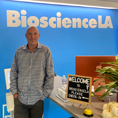 David in front of the Bioscience LA logo