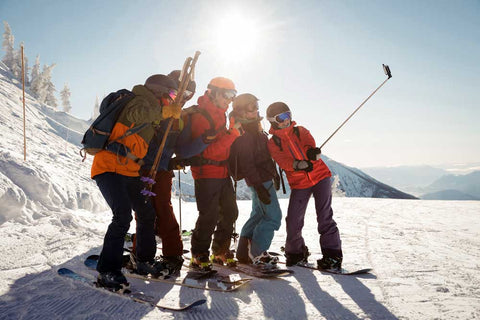 group-skiers-taking-selfie-mobile-phone-wearing-upf-legging-scarf