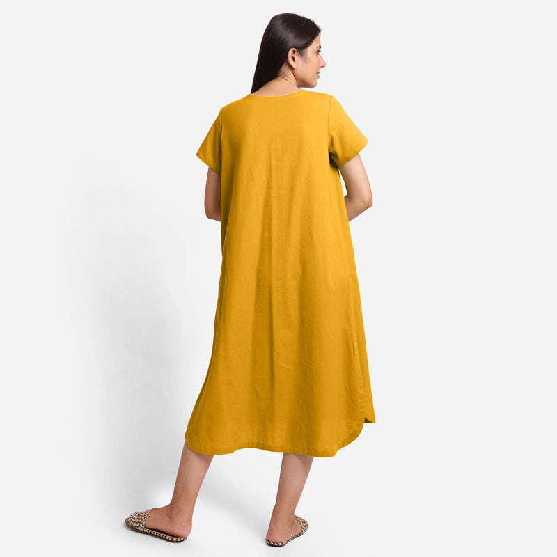 Back View of a Model wearing Yellow Cotton Welt Pocket Shift Dress