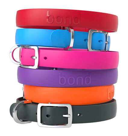 A stack of BOND collars in colours Tangerine Orange, Grape Purple, Raspberry Pink, Black Pepper, Tomato Red