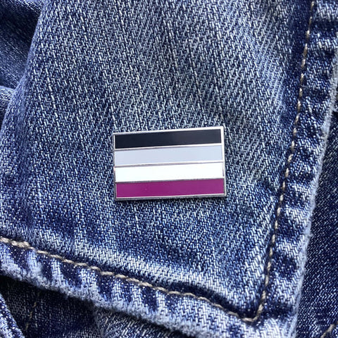 wearable asexual pride flag enamel pin on a denim jacket