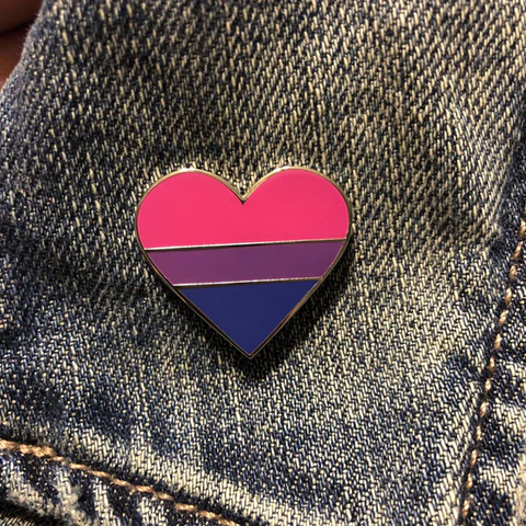 Bisexual pride enamel pin on a denim jacket