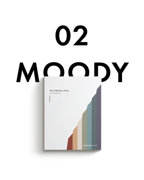 Moody rainbow softcover photo book with text behind product.