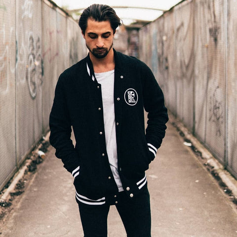 Male model wearing black varsity jacket