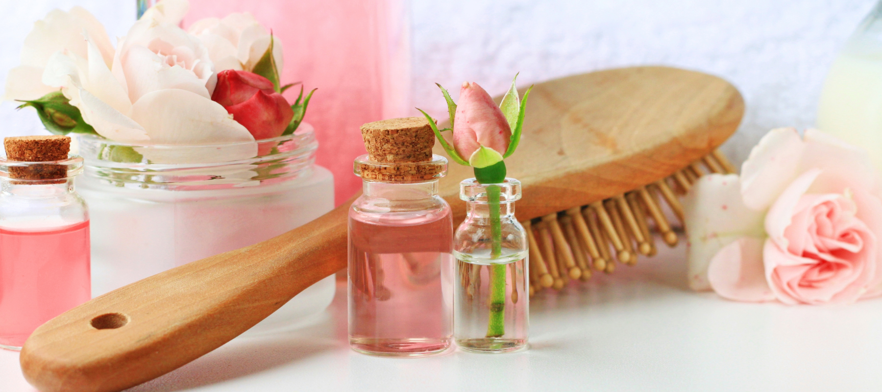 Roses, rose water, and a wooden brush