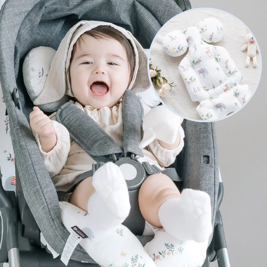 A baby sitting on a stroller