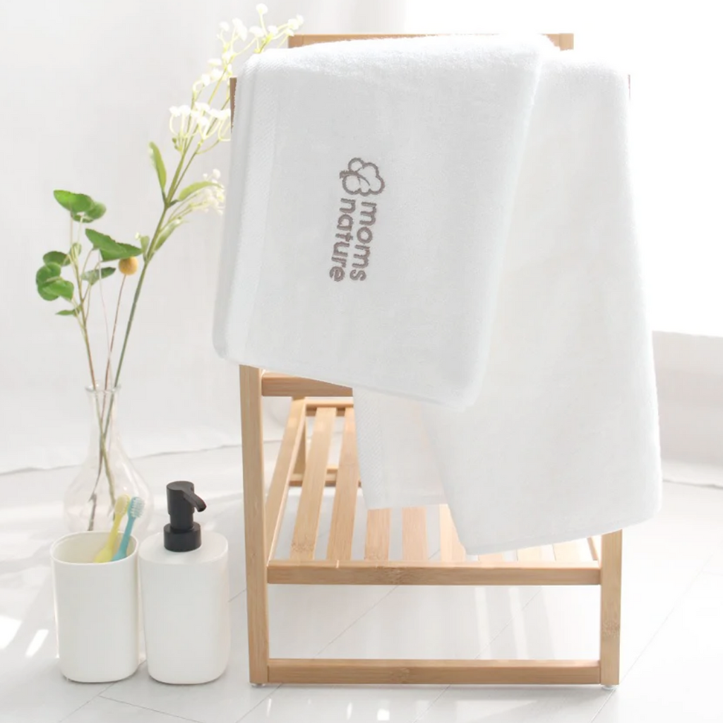 A small table with two sets of towels hanging