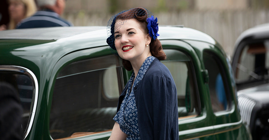 Dudley-West-Midlands-united-kingdom-July-13-2019-young-women-portrait-standing-smiling-next-to-a-green-car-1940s-concept