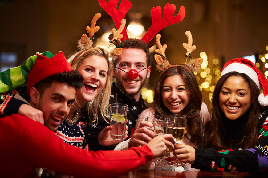 Group-Of-Friends-Enjoying-Christmas-Drinks-In-Bar
