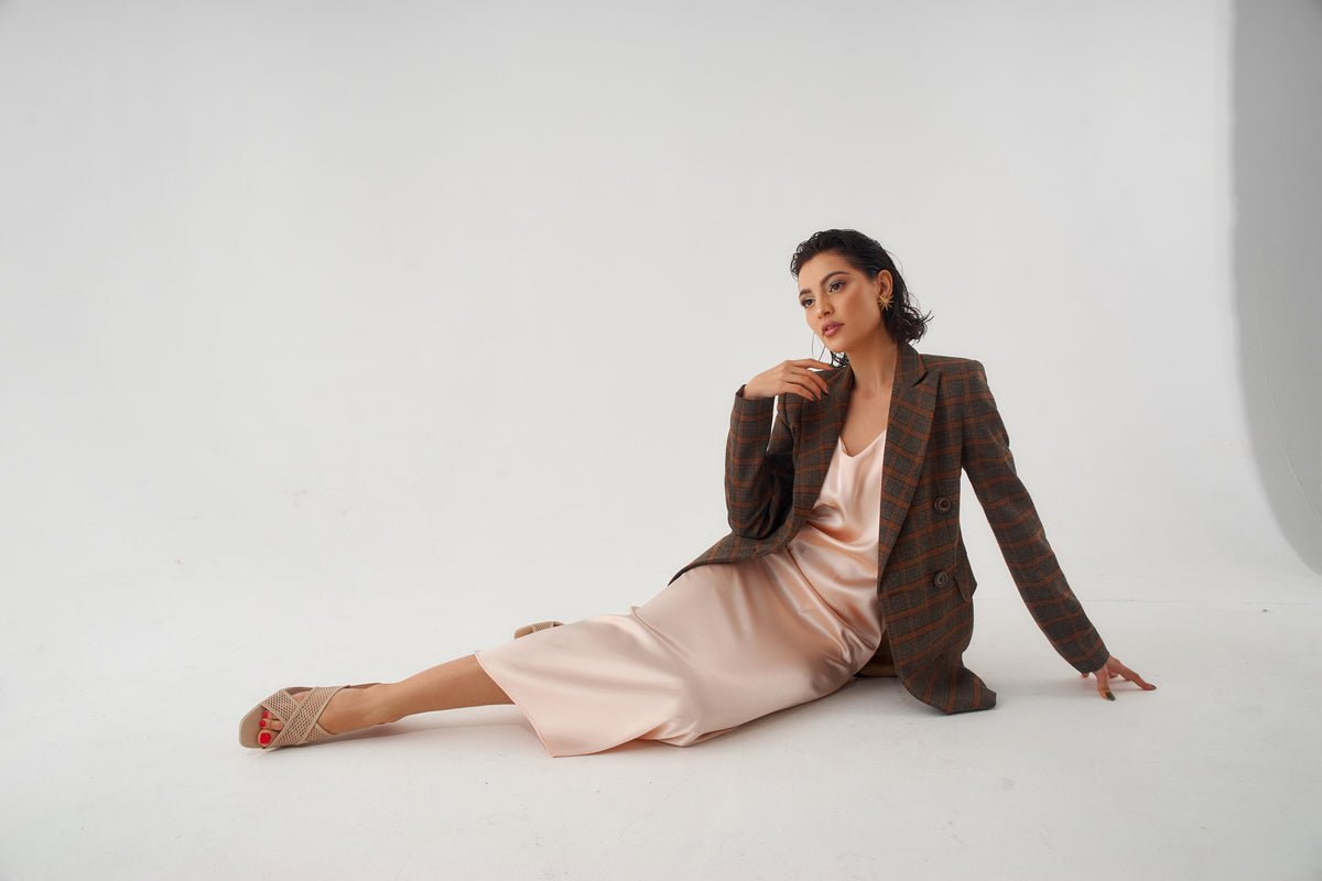 Model poses in dress and blazer